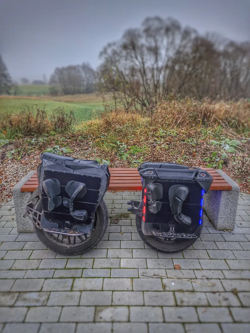 Two EUC wheels resting on a bench